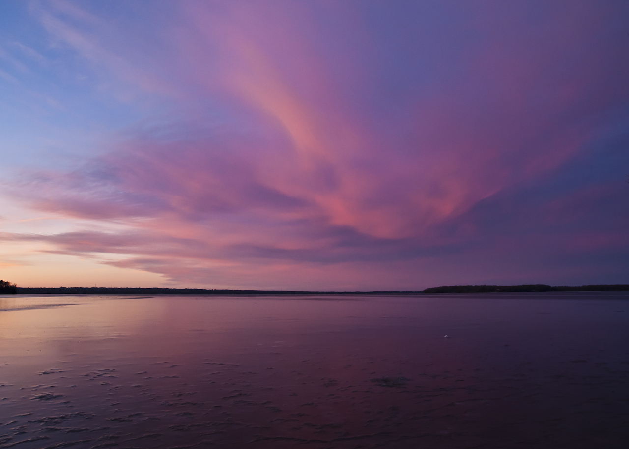 A sunset reflected in a still lake