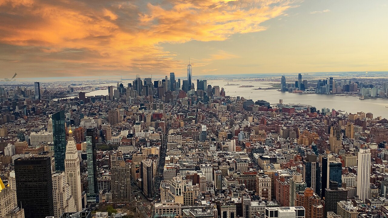 The dense skyline of Manhattan at dusk, packed with high-rise buildings