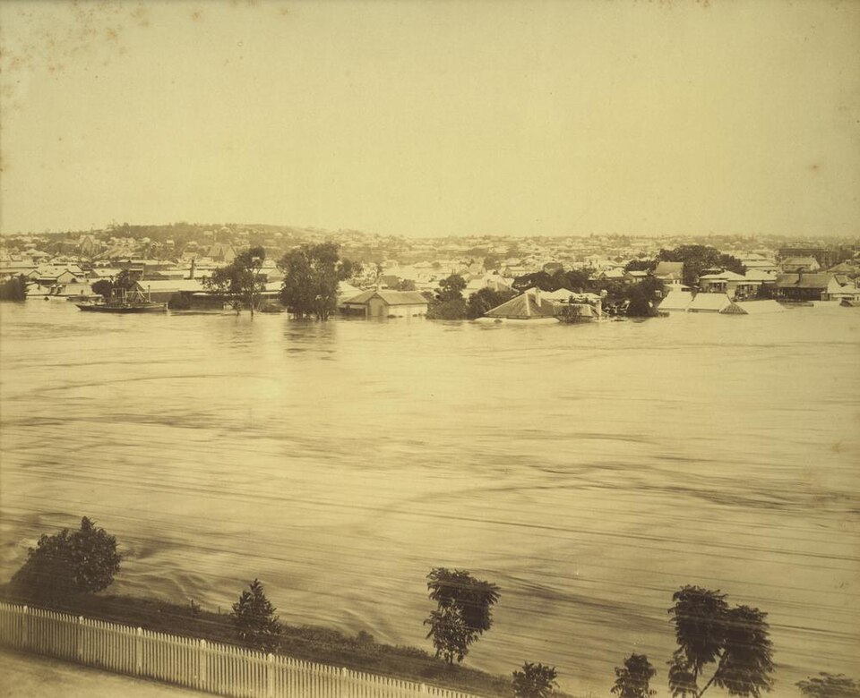 A river in flood with houses submerged in the water