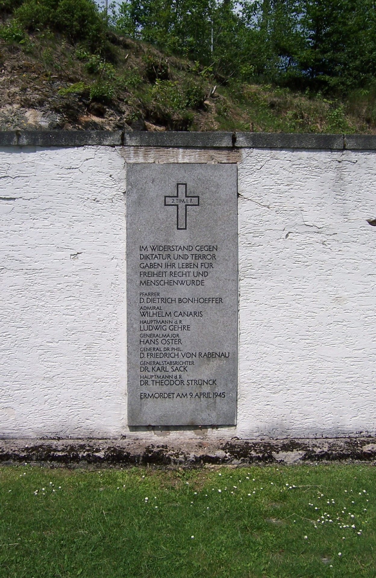 Memorial plaque mounted on a stone wall listing Bonhoeffer among those executed, dated April 9, 1945