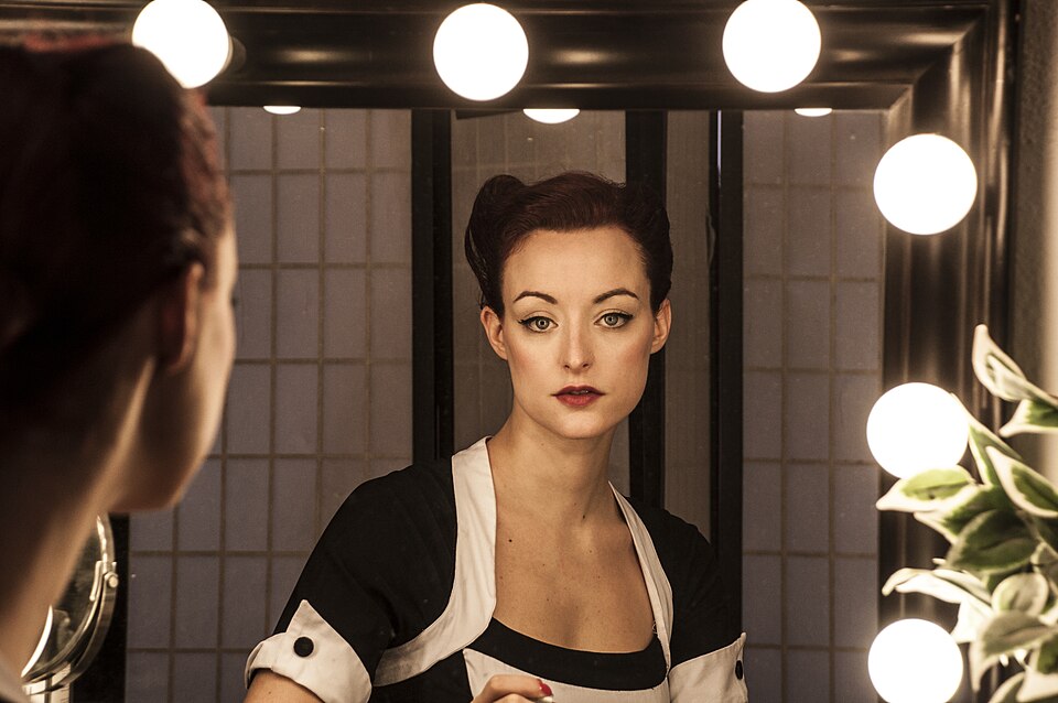 A person looking at their own face in a mirror