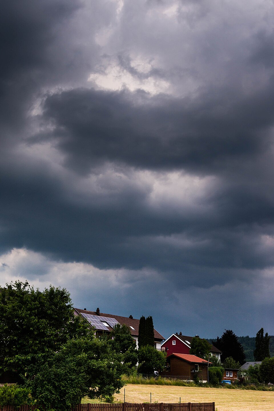 Dark storm clouds gathering over houses
