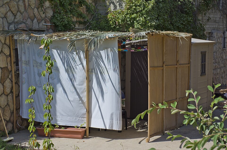 A sukkah booth roofed with branches