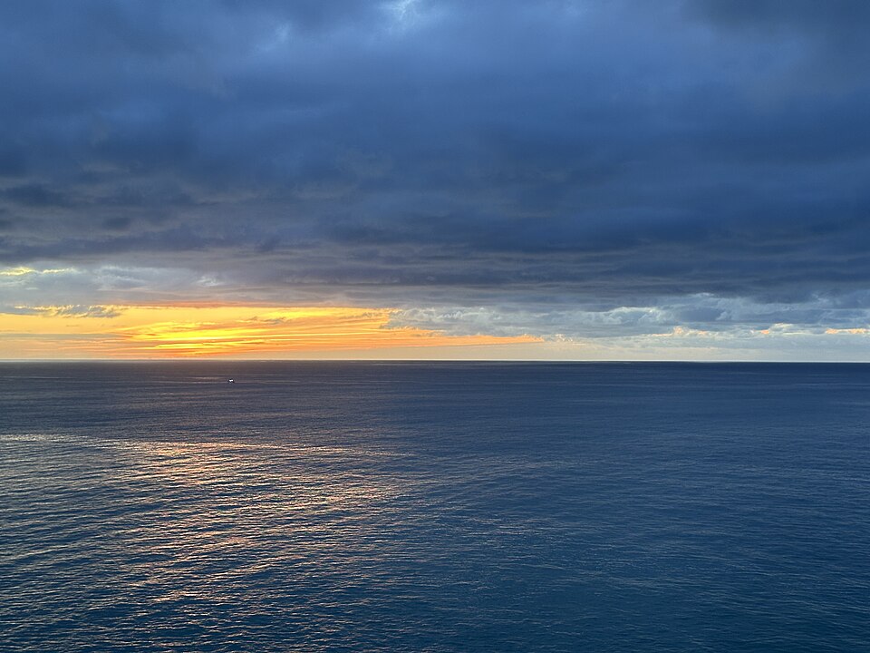 Dawn breaking over dark waters