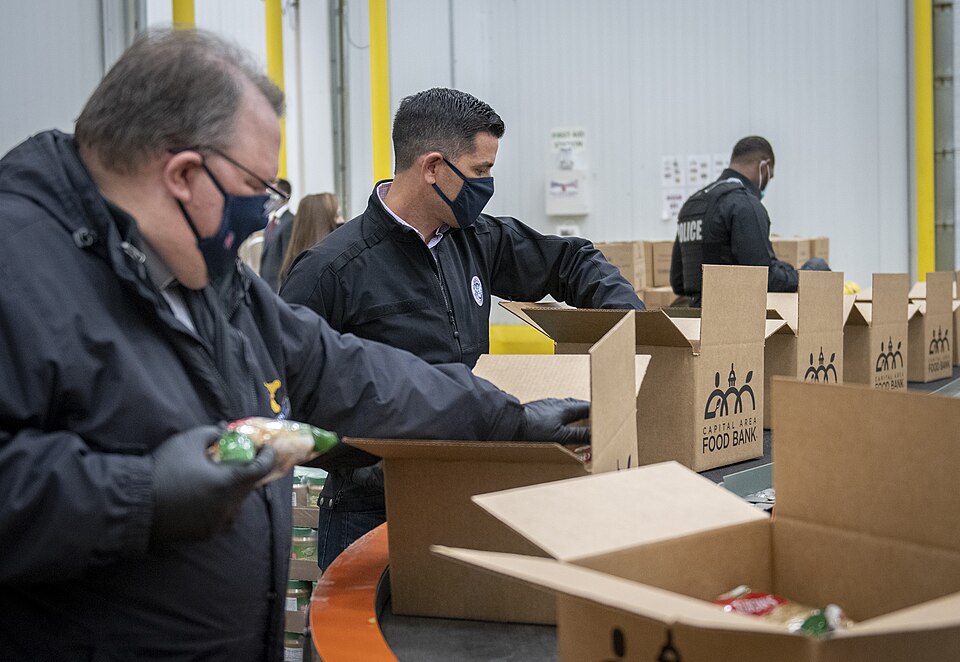 Volunteers packing food into boxes at a food bank